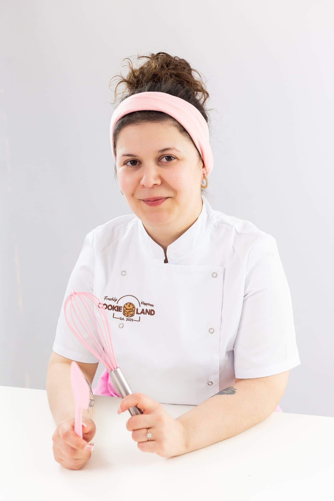 Cookieland founder sitting with her pink whisk