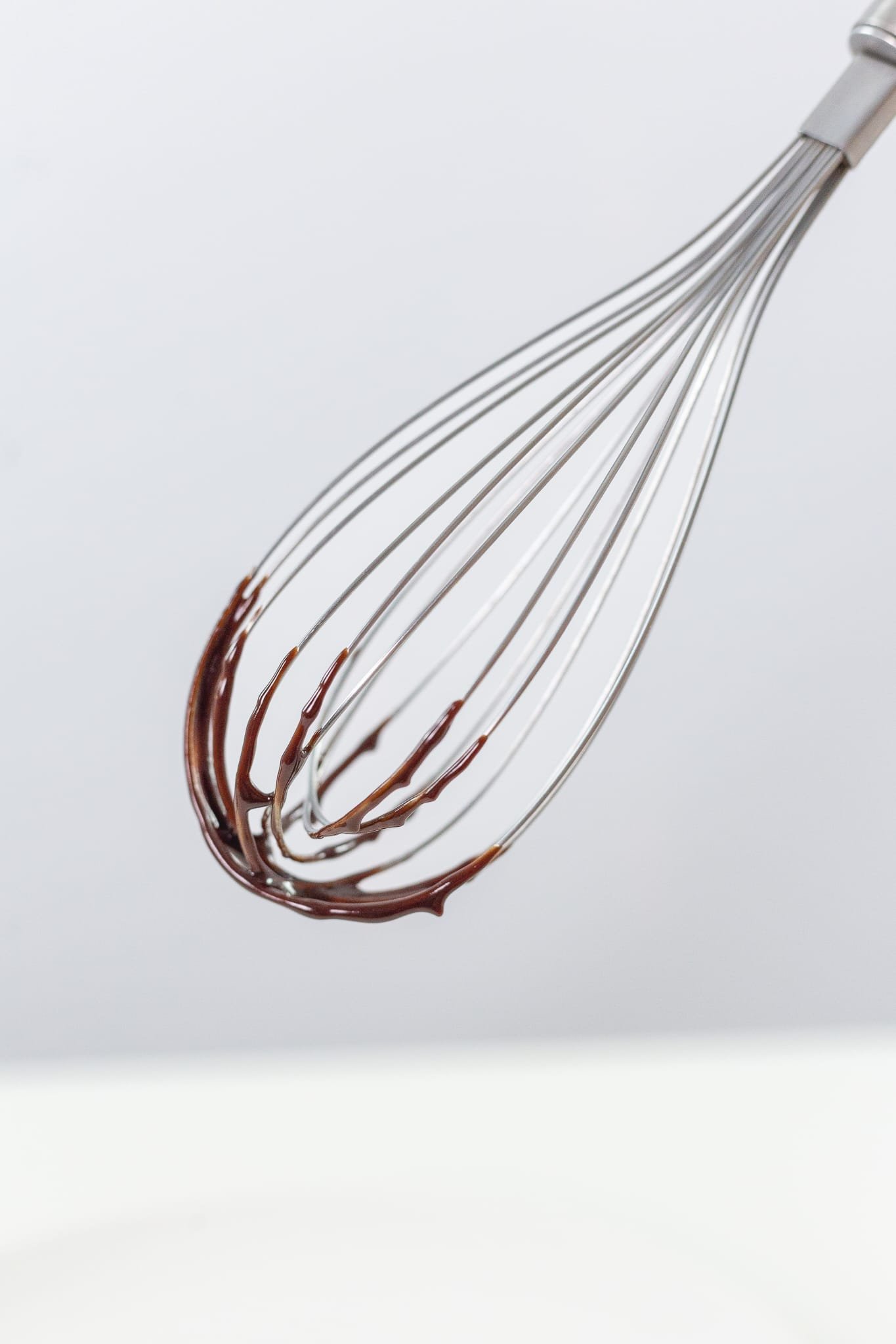Whisk covered in chocolate ganache
